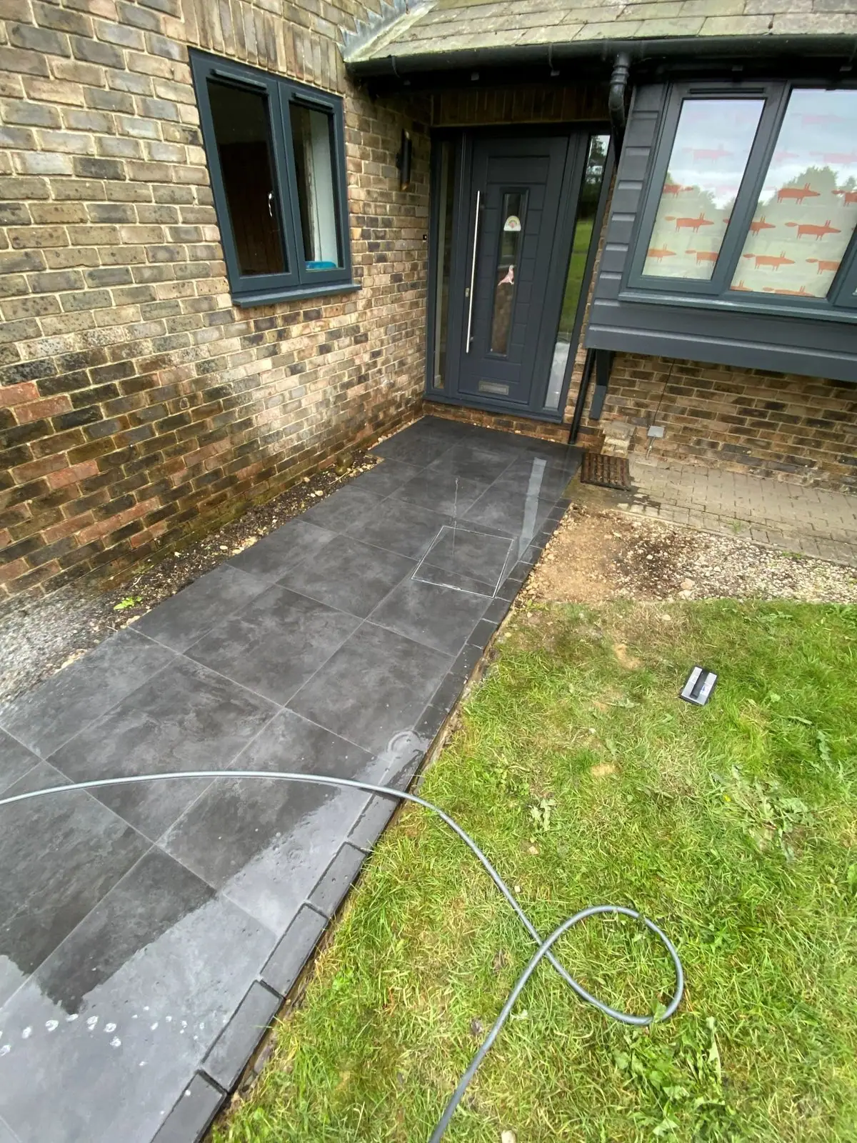 Dark porcelain path leading to the front door