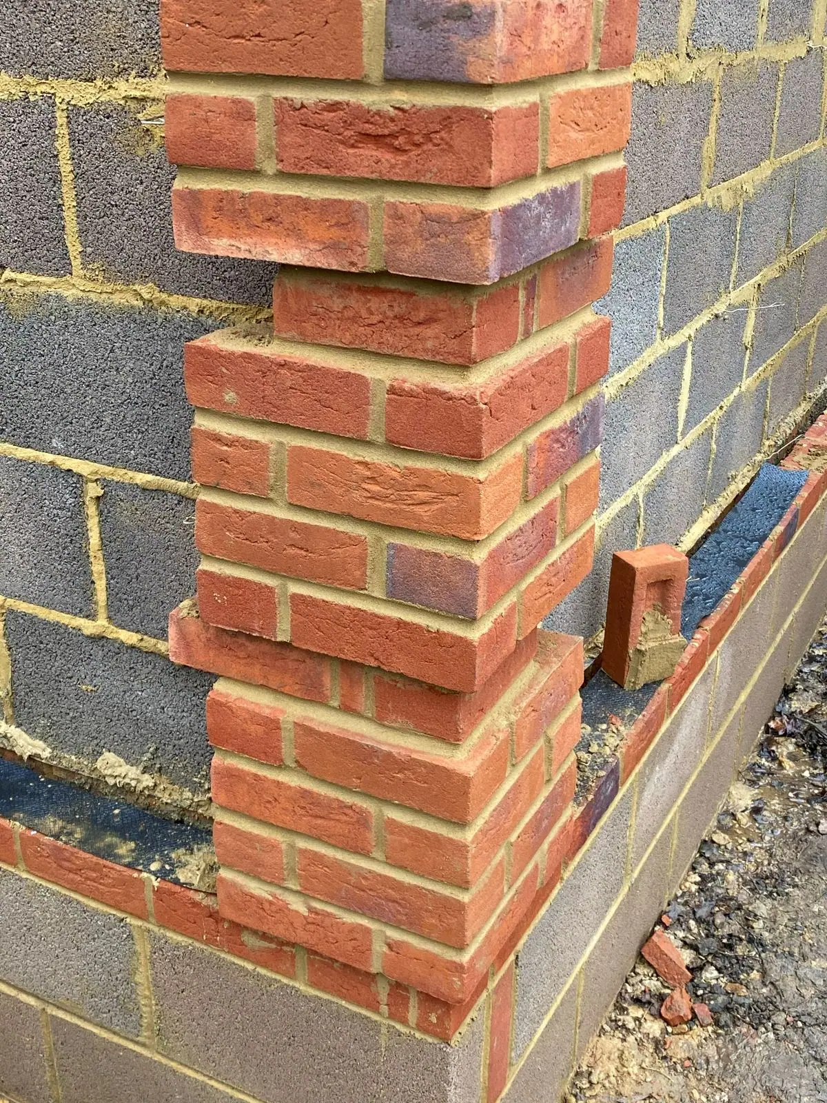 Facing brick corner built against the blockwork