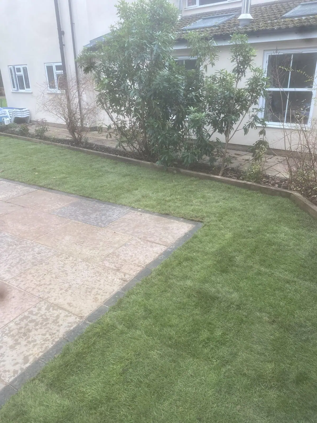 Sandstone paving meeting new lawn