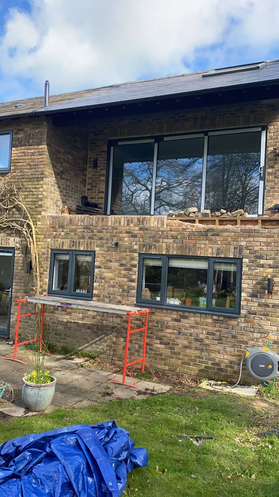 Two-storey brick rear extension with large first-floor windows