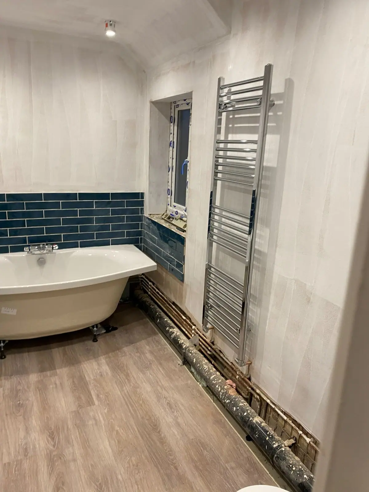 Heated towel rail beside the window