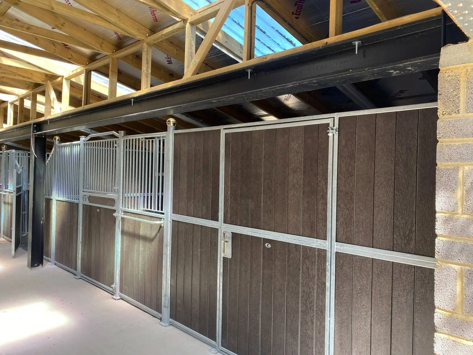Inside the stable block: stalls along a central aisle