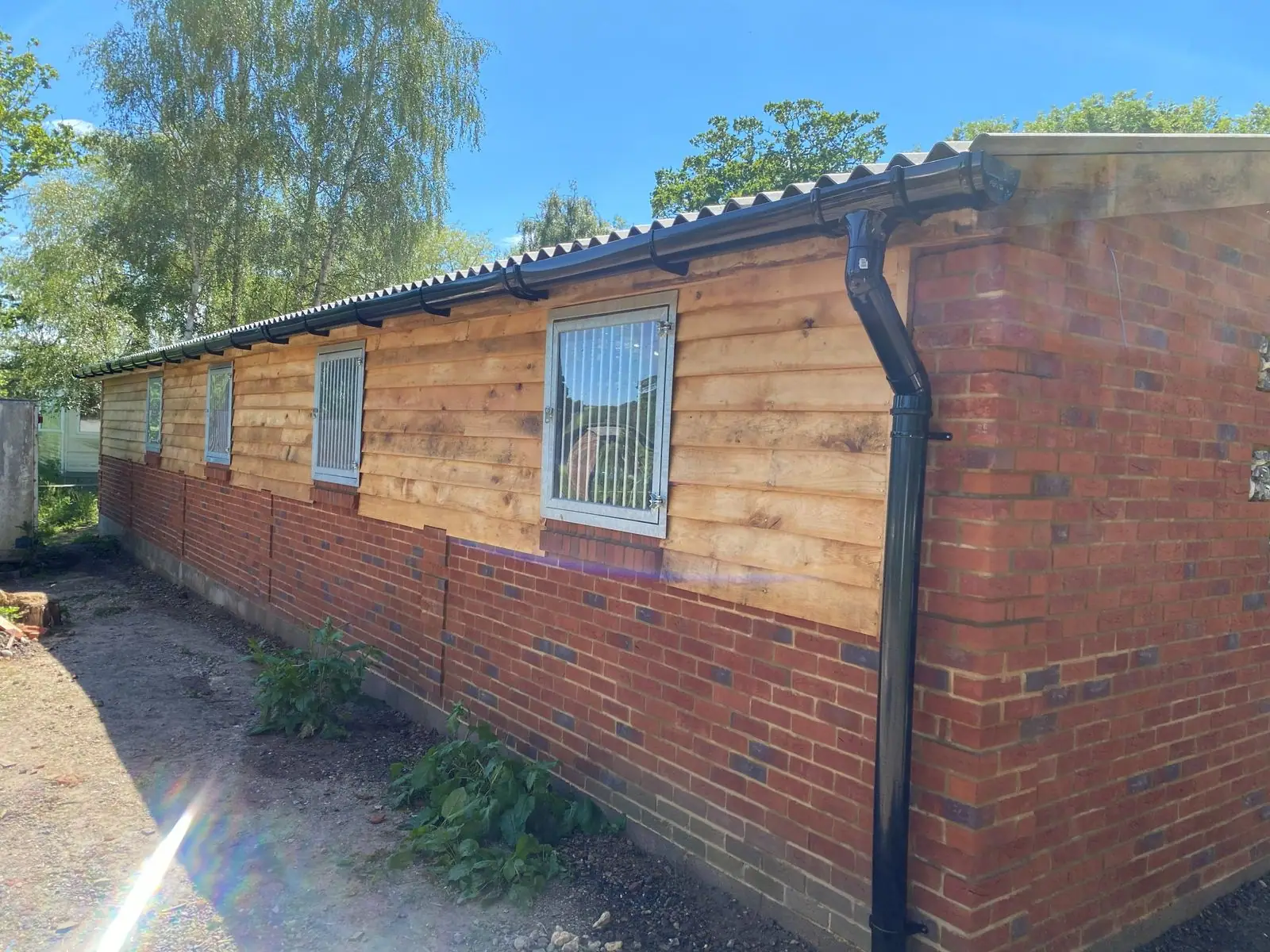 Side of the stable block with guttering and downpipes
