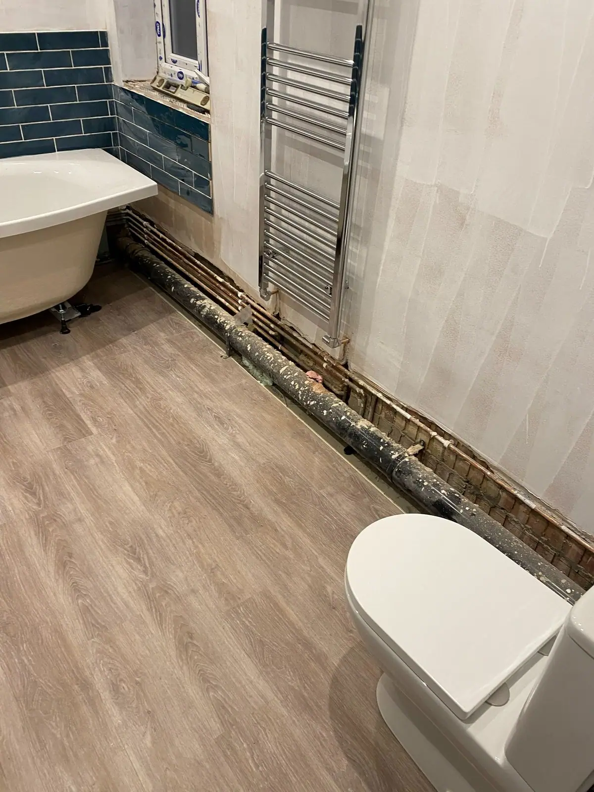 Freestanding bath, towel rail and toilet