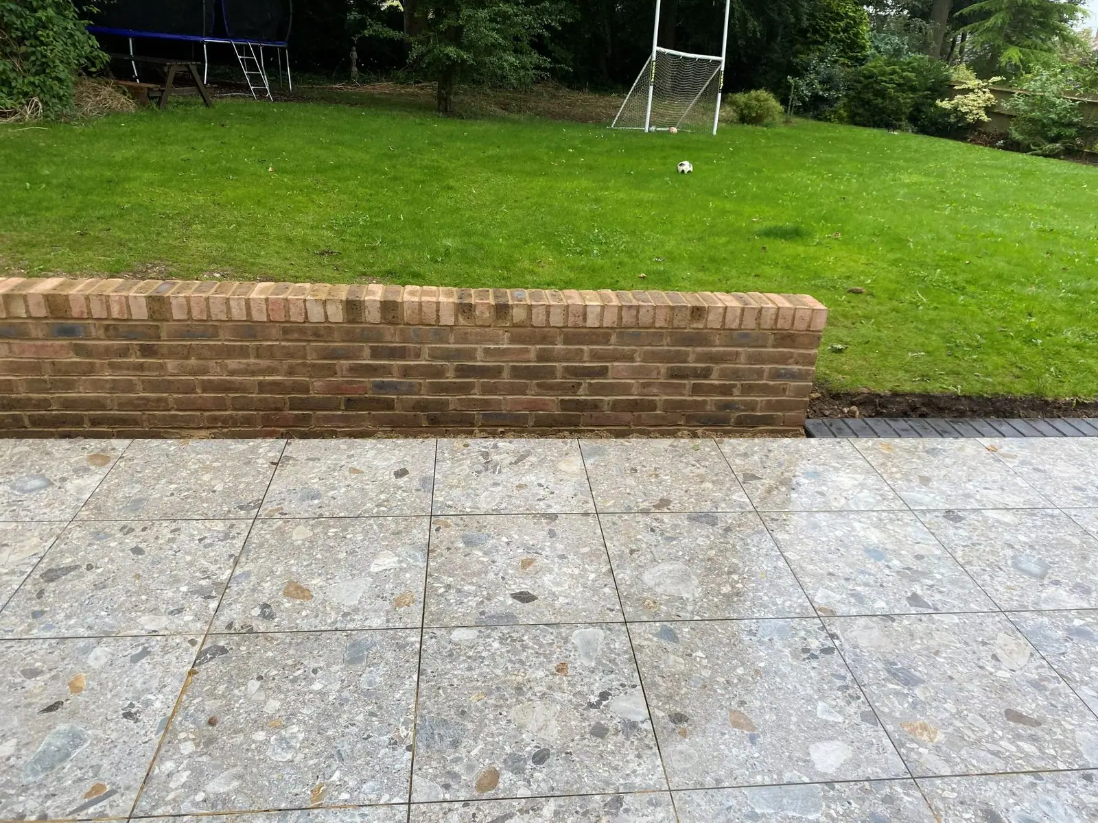 Brick retaining wall along the patio